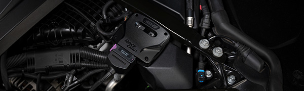 RaceChip GTS 5 control unit installed in an engine bay with the OEM connector plugged in.